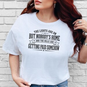 Funny Adult Humor Shirt, Sarcastic Adulting Tee, The Lights Are On But Nobody's Home and Bills Are Getting Paid Somehow, Gen X Gift image 4