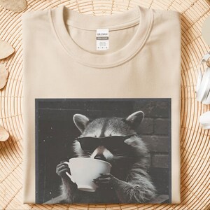Funny Raccoon Sipping A Cup Of Tea Tee, Sarcastic Trash Panda Retro Wildlife Graphic Shirt, Humorous Animal Lover Tea Drinker Gift image 1