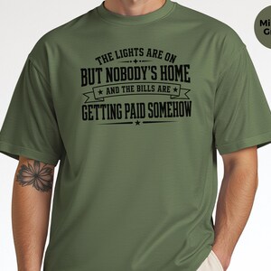 Funny Adult Humor Shirt, Sarcastic Adulting Tee, The Lights Are On But Nobody's Home and Bills Are Getting Paid Somehow, Gen X Gift image 2