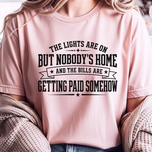 Funny Adult Humor Shirt, Sarcastic Adulting Tee, The Lights Are On But Nobody's Home and Bills Are Getting Paid Somehow, Gen X Gift image 7