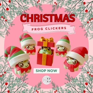 May include: A festive image featuring Christmas frog clickers. The frogs are wearing Santa hats and elf outfits, with one frog inside a red gift box. The background is pink with Christmas tree branches and the text "CHRISTMAS FROG CLICKERS".
