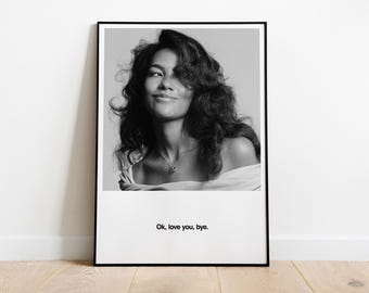 May include: Monochrome framed print of a woman with curly hair, wearing a necklace, and smiling. The print includes the text "Ok, love you, bye." at the bottom. The frame is black, and the print is displayed on a white wall.