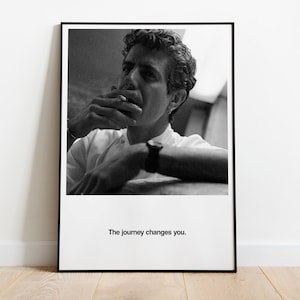 May include: Black and white photograph of a man smoking a cigarette. The man is wearing a white shirt and has short, dark hair. The text "The journey changes you." is printed below the image.