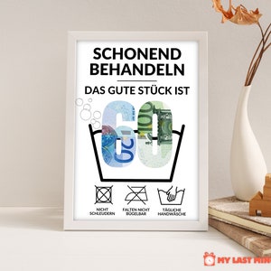 May include: A white framed poster with black text that reads "Schonend Behandeln Das Gute St&uuml;ck Ist 60" with a picture of a washing instruction symbol with the number 60 made of euro bills. Below the symbol are three more washing instructions: "Nicht Schleudern", "Falten Nicht B&uuml;gelbar", and "T&auml;gliche Handw&auml;sche".