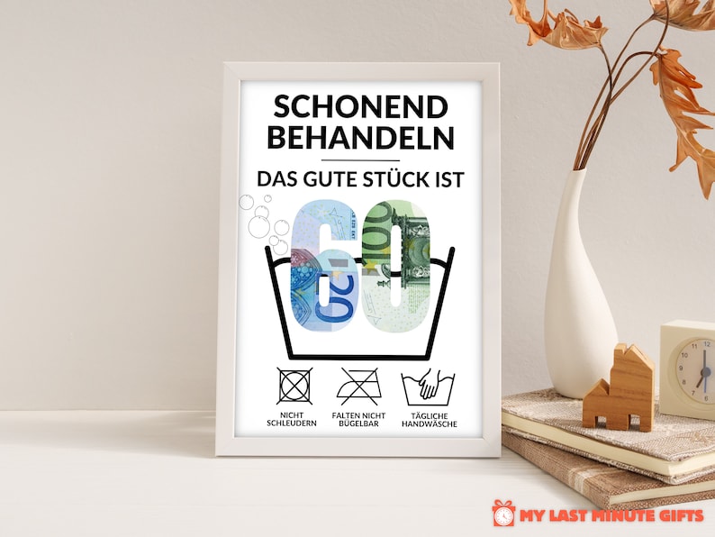 May include: A white framed poster with black text that reads "Schonend Behandeln Das Gute St&uuml;ck Ist 60" with a picture of a washing instruction symbol with the number 60 made of euro bills. Below the symbol are three more washing instructions: "Nicht Schleudern", "Falten Nicht B&uuml;gelbar", and "T&auml;gliche Handw&auml;sche".