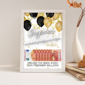 Può includere: Una cornice bianca con sfondo bianco e palloncini neri e dorati. Il testo "Joyeux anniversaire a toi" è scritto in nero. Una banconota falsa da 100.000 euro è nella cornice con il testo "Amuse-toi bien avec ton premier million!"