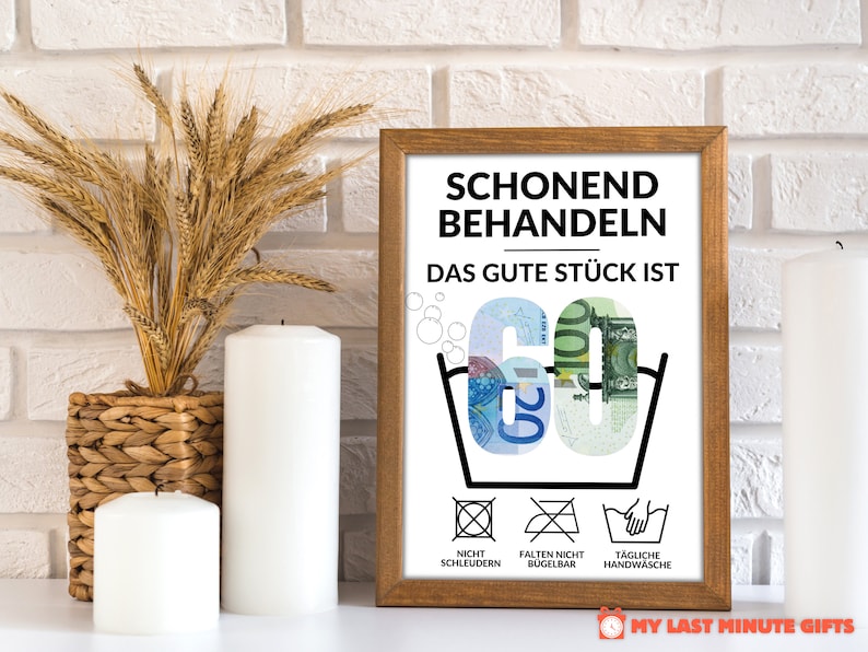 May include: A white framed print with the text "Schonend Behandeln Das Gute St&uuml;ck Ist 60" in black. The number 60 is made of euro bills. Below the text are three laundry care symbols: "Nicht Schleudern", "Falten Nicht B&uuml;gelbar", and "T&auml;gliche Handw&auml;sche".