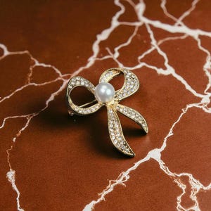 Elegante Schleifen Brosche mit Perle in der Mitte, Gold Strass Band Pin, Vintage Style Kristall Schleife Pin, Brautjungfer Schmuck Geschenk