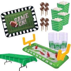 May include: A collection of football-themed party supplies. Includes a serving tray with "GAME ON!" text, football-shaped food picks, popcorn containers, clear cups, a table cover, and an inflatable cooler.