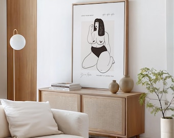 Puede incluir: Una lámina de arte enmarcada con un dibujo de líneas negras de una persona arrodillada con ropa interior negra. El texto dice LOVE YOUR BODY, You are Perfect y THE WAY IT LOVES YOU. La impresión está sobre un fondo beige claro.