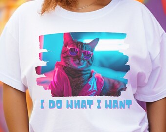 May include: White t-shirt featuring a graphic of a cat wearing sunglasses and a pink jacket. The text "I do what I want" is printed below the cat.