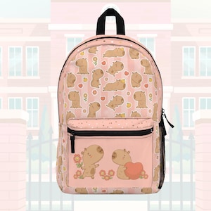 May include: A light pink backpack featuring a repeating pattern of cartoon capybaras, small flowers, and fruit. The front pocket displays two capybaras, one holding a flower and the other holding a heart. The bag has black zippers and straps.