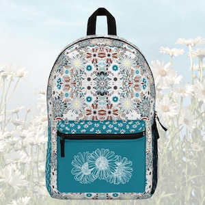 May include: A floral-patterned backpack with a teal front pocket featuring white daisy outlines. The main body displays a repeating pattern of flowers in white, teal, and brown. It has a black handle and zipper.