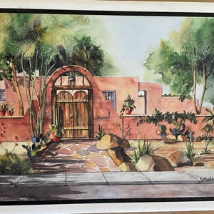 May include: Watercolor painting of a terracotta-colored house with a wooden door and a stone walkway. The house is surrounded by lush greenery and cacti. The painting is signed "D. Madaras".