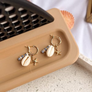 Gold Filled Hoop Earrings with Cowrie Shell, Blue Bead & Starfish Charm – Beach Earrings, Ocean Jewelry, Boho Dangle Hoops