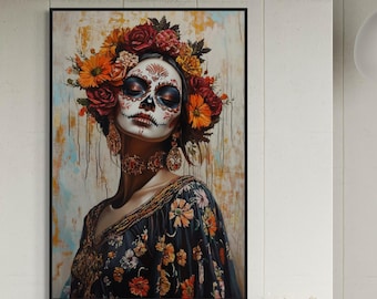 May include: A framed wall art print featuring a portrait of a person with intricate sugar skull face paint, adorned with a vibrant crown of red and orange flowers, wearing a dark floral patterned garment and ornate gold jewelry.