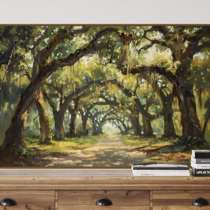 May include: A painting depicting a path through a woodland, featuring trees with hanging moss. The trees are green and the path is dirt. The painting is framed in a gold frame.