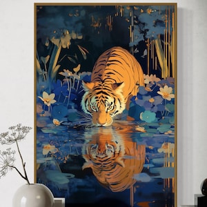 A majestic tiger drinks from a calm lake, its reflection glowing in golden hues. Surrounded by blue flowers and soft light, this art print blends nature with elegance, perfect for boho, nature, or wildlife-themed home decor.