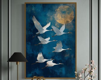 May include: A rectangular wall art print featuring five white cranes in flight against a deep blue, textured night sky with a large, glowing golden moon. The artwork is framed in a thin gold border and displayed on a wall.
