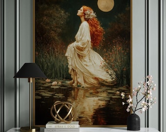 May include: A framed wall art print depicting a person with long red hair wearing a flowing white gown, standing in a dark pond filled with lily pads under a full moon. The scene features tall grasses and orange flowers in a moody, nocturnal setting.