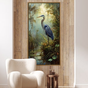 A serene Blue Heron stands amidst a lush wetland oasis, its graceful form bathed in dappled sunlight filtering through a verdant canopy. Perfect for a tranquil decor piece.