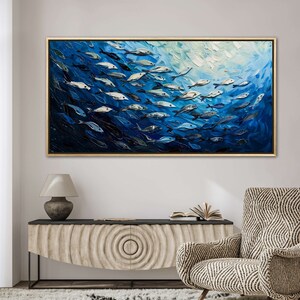 A dynamic school of fish swims in unison through the tranquil blue sea, their silvery scales reflecting light, depicted with thick, textured brushstrokes that give life and movement to this captivating marine scene.