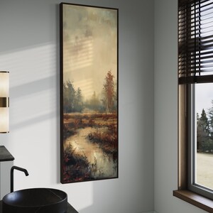 This atmospheric painting captures a moody landscape with a dramatic interplay of light and shadow. A muted palette conveys the serenity of a misty marshland, evoking a sense of quiet introspection.