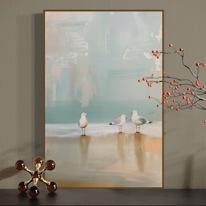Serene Shoreline Trio: Three seagulls stand in quiet contemplation, their crisp white feathers a calm contrast to the creamy shoreline backdrop.