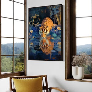 A majestic tiger drinks from a calm lake, its reflection glowing in golden hues. Surrounded by blue flowers and soft light, this art print blends nature with elegance, perfect for boho, nature, or wildlife-themed home decor.