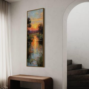 Impressionist landscape art of a glowing sunset over a peaceful waterway with lily pads and tall grasses. The golden light reflects on the calm water, surrounded by soft trees and vibrant colors. A serene nature scene perfect for rustic, cottage, or lake house decor.