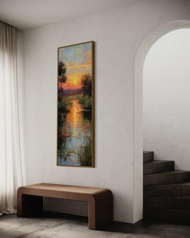 Impressionist landscape art of a glowing sunset over a peaceful waterway with lily pads and tall grasses. The golden light reflects on the calm water, surrounded by soft trees and vibrant colors. A serene nature scene perfect for rustic, cottage, or lake house decor.