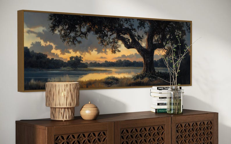 Capturing the tranquil essence of dusk, this panoramic artwork features a majestic oak tree overlooking a serene river, illuminated by the golden hues of a setting sun.