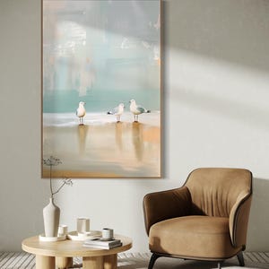 Serene Shoreline Trio: Three seagulls stand in quiet contemplation, their crisp white feathers a calm contrast to the creamy shoreline backdrop.