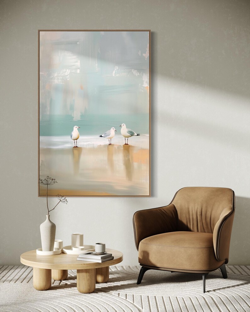 Serene Shoreline Trio: Three seagulls stand in quiet contemplation, their crisp white feathers a calm contrast to the creamy shoreline backdrop.