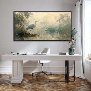 A serene heron stands amidst a tranquil swamp, reflected in the calm waters, set against a backdrop of ethereal, golden-hued trees and a soft, diffuse light that permeates this peaceful landscape painting.