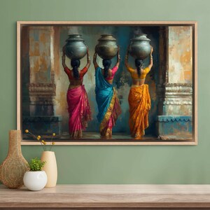 Celebrate cultural beauty with this vibrant art piece depicting three Indian women in colorful saris, gracefully carrying pots on their heads. The rich textures and warm tones make it a stunning addition to any space.