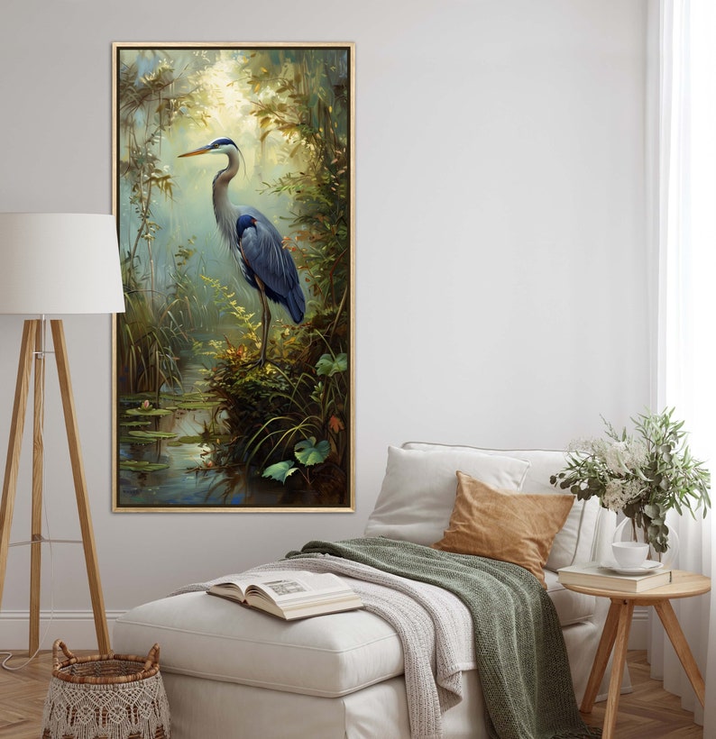 A serene Blue Heron stands amidst a lush wetland oasis, its graceful form bathed in dappled sunlight filtering through a verdant canopy. Perfect for a tranquil decor piece.