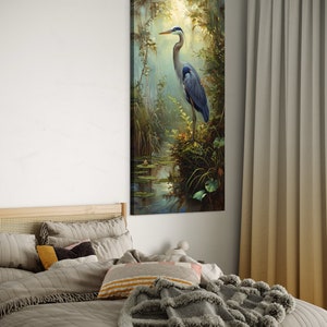A serene Blue Heron stands amidst a lush wetland oasis, its graceful form bathed in dappled sunlight filtering through a verdant canopy. Perfect for a tranquil decor piece.