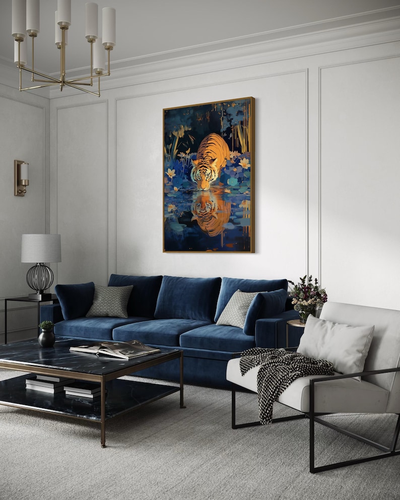 A majestic tiger drinks from a calm lake, its reflection glowing in golden hues. Surrounded by blue flowers and soft light, this art print blends nature with elegance, perfect for boho, nature, or wildlife-themed home decor.