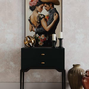 Romantic artwork of a Mexican couple in traditional attire, adorned with vibrant floral embroidery. Their intimate pose and exquisite details evoke passion and cultural elegance, perfect for adding warmth and charm to your home.