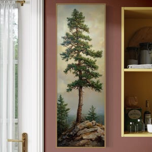 May include: A vertical painting of a tall pine tree on a rocky cliff. The tree is green and the sky is a light blue with clouds. The painting is framed in gold.