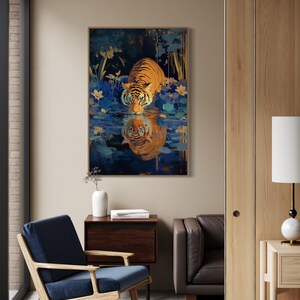 A majestic tiger drinks from a calm lake, its reflection glowing in golden hues. Surrounded by blue flowers and soft light, this art print blends nature with elegance, perfect for boho, nature, or wildlife-themed home decor.