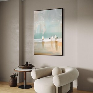 Serene Shoreline Trio: Three seagulls stand in quiet contemplation, their crisp white feathers a calm contrast to the creamy shoreline backdrop.
