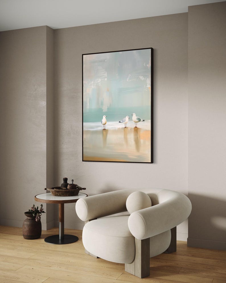 Serene Shoreline Trio: Three seagulls stand in quiet contemplation, their crisp white feathers a calm contrast to the creamy shoreline backdrop.