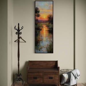 Impressionist landscape art of a glowing sunset over a peaceful waterway with lily pads and tall grasses. The golden light reflects on the calm water, surrounded by soft trees and vibrant colors. A serene nature scene perfect for rustic, cottage, or lake house decor.