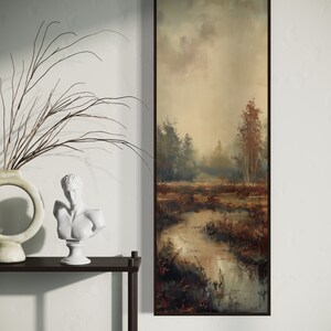 This atmospheric painting captures a moody landscape with a dramatic interplay of light and shadow. A muted palette conveys the serenity of a misty marshland, evoking a sense of quiet introspection.