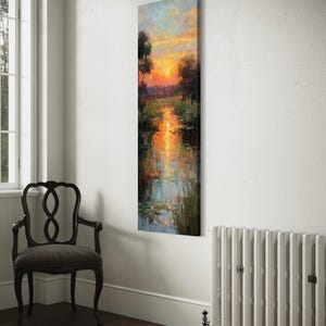 Impressionist landscape art of a glowing sunset over a peaceful waterway with lily pads and tall grasses. The golden light reflects on the calm water, surrounded by soft trees and vibrant colors. A serene nature scene perfect for rustic, cottage, or lake house decor.