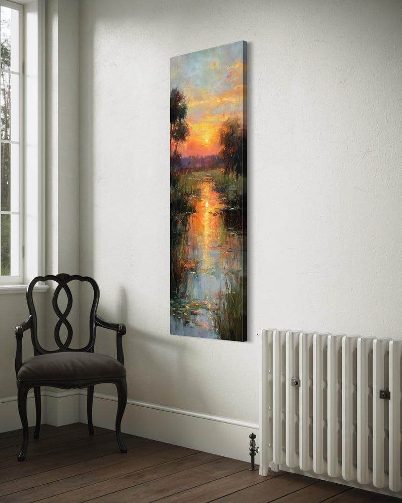Impressionist landscape art of a glowing sunset over a peaceful waterway with lily pads and tall grasses. The golden light reflects on the calm water, surrounded by soft trees and vibrant colors. A serene nature scene perfect for rustic, cottage, or lake house decor.