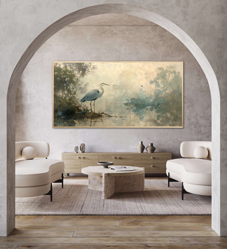 A serene heron stands amidst a tranquil swamp, reflected in the calm waters, set against a backdrop of ethereal, golden-hued trees and a soft, diffuse light that permeates this peaceful landscape painting.