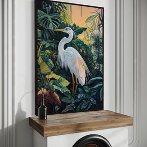 This canvas print captures a majestic heron standing amidst lush tropical foliage, illuminated by a soft, golden sunrise. Its detailed portrayal and vibrant setting make it a striking piece for any nature or bird enthusiast's collection.